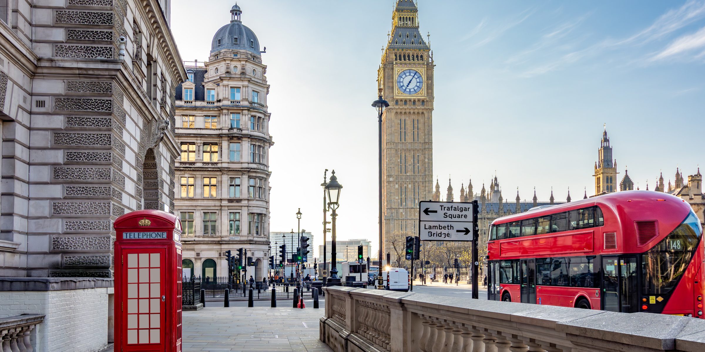 Red telephone box and double-decker bus on Parliament square and Big Ben tower, London, UK
