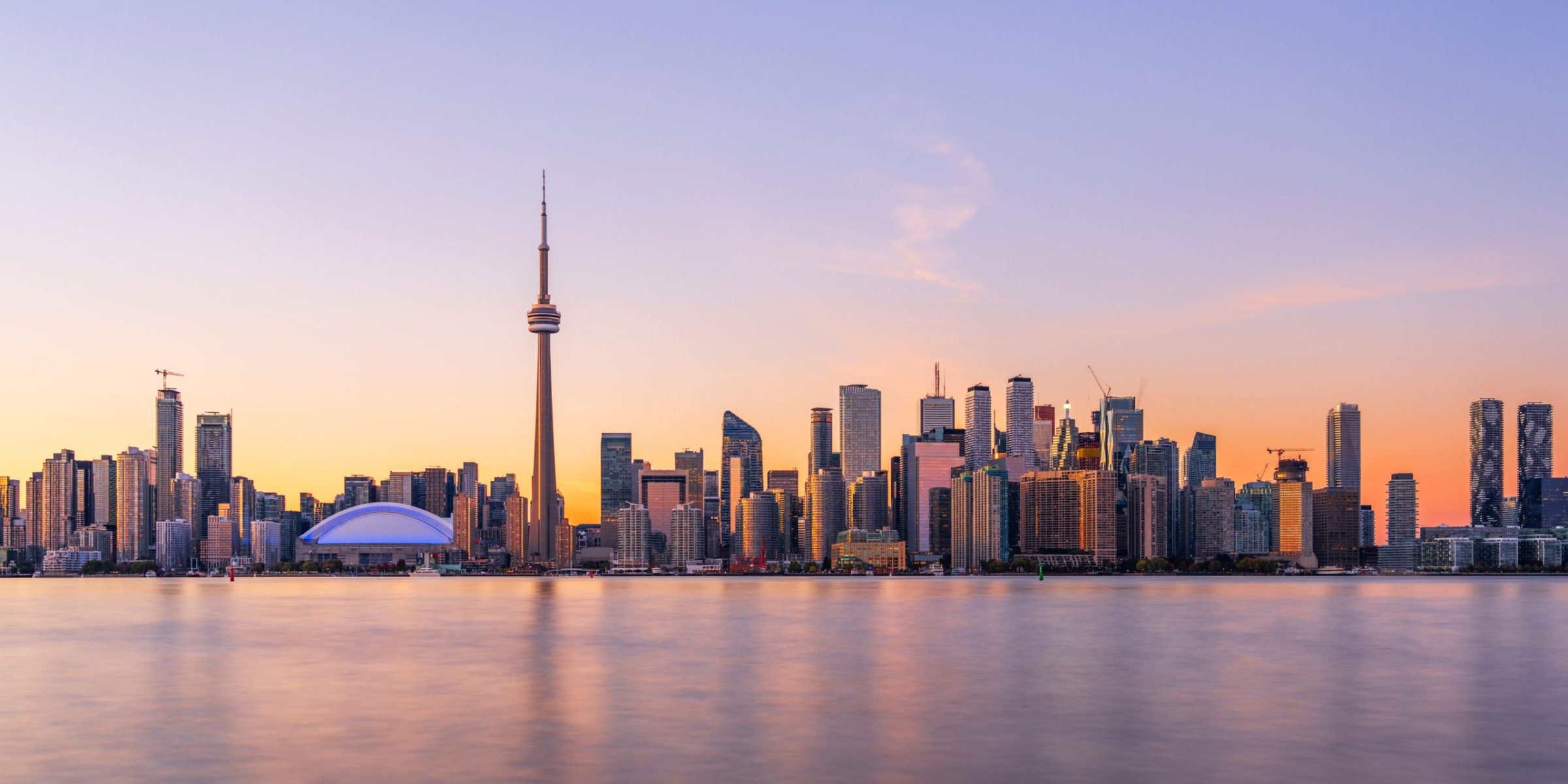 Toronto, Ontario, Canada downtown city skyline on lake Ontario at twilight.